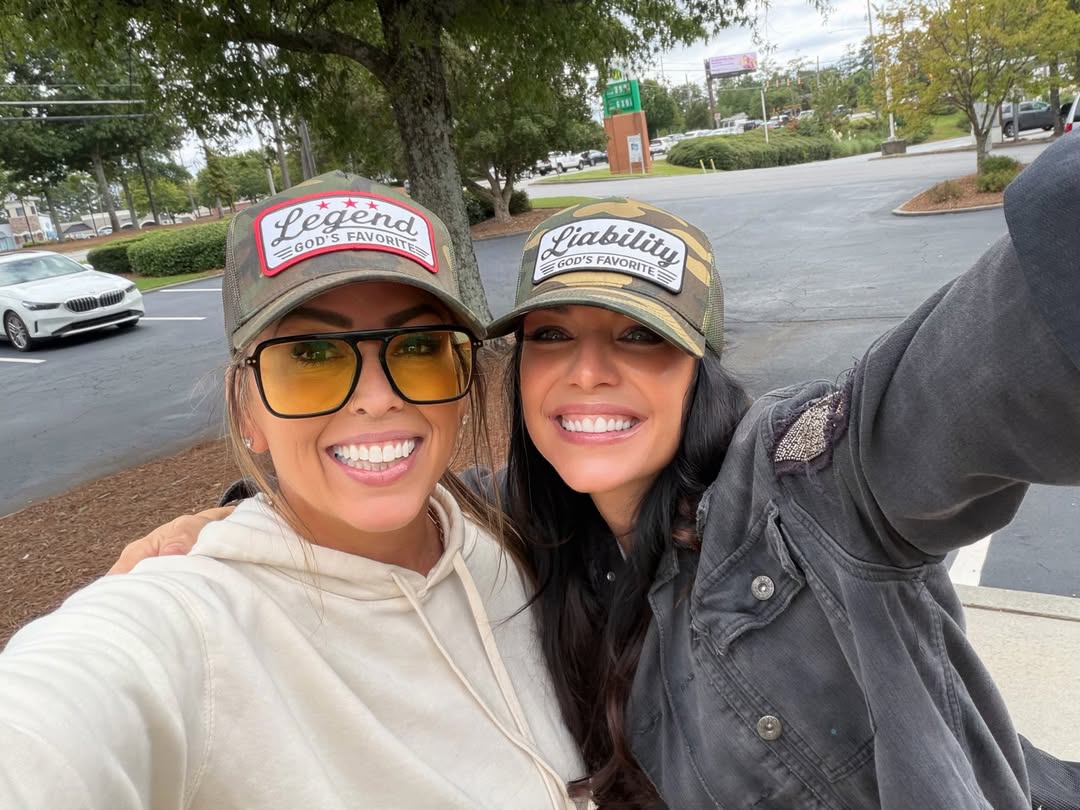 Jaynie & Anitra, founders of Identity Badge, wearing Legend and Liability hats